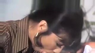 Asian woman gives a passionate blowjob in a vintage film.